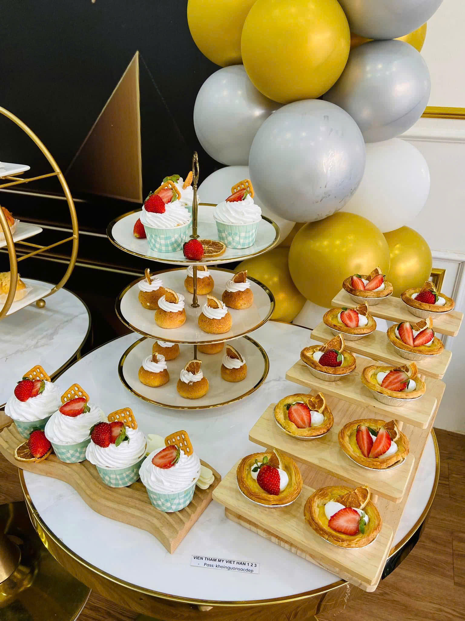 Bàn tea break tông vàng trắng với cupcake và tart dâu